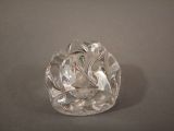 a clear glass object on a table with a gray background