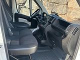 the interior of a van with the door open and the driver ' s seat down