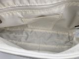 a white purse that is open on a white table