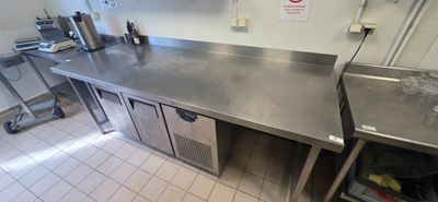 a large stainless steel counter in a commercial kitchen