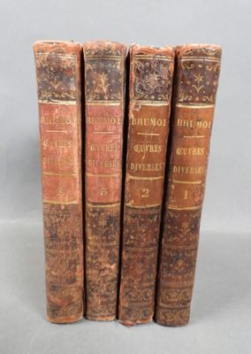 three old books sitting on top of each other on a table