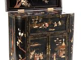 an image of a black and gold decorated cabinet with drawers and drawers