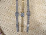two watches that are sitting on a woven basket