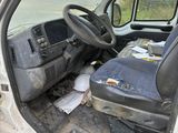a dirty truck with a seat and a seat in the back