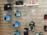 a wall of electronics on display in a store
