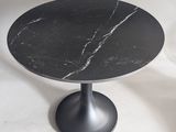 black marble table with a black pedestal on a white background