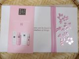 the box is open on a wicker basket with a pink ribbon