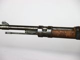 an old rifle with a wooden barrel on a white background