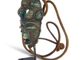 an image of a bronze statue of a man with a rope around his neck