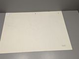 a white sheet of paper on the floor in the corner of a room