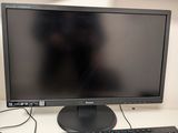 a computer monitor and keyboard on a desk with a mouse