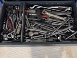a tool box full of wrenches sitting on a table