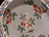 a bowl with a fish design on it on a table