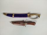 two different types of pens and a knife on a table
