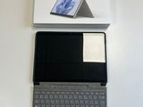 a laptop computer sitting on top of a white box