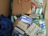 a cardboard box full of items in the corner of a room