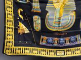 an image of a scarf with egyptian symbols on it hanging on a wall