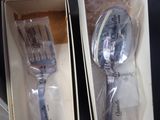 two forks and a spoon in a box