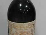 a bottle of wine sitting on a table next to a bottle of wine