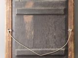 a picture of a wooden frame with a rope attached to it