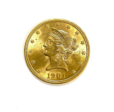 a close up of a gold coin with a woman ' s head on it