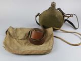 pair of military canteens with leather straps and a canvas bag