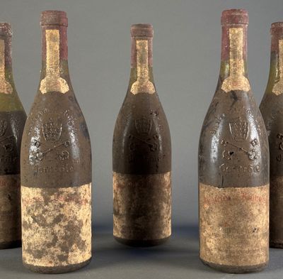 six bottles of wine are lined up in a row