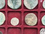 some of the ancient coins are in a red display case