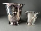 two silver vases sitting next to each other on a table