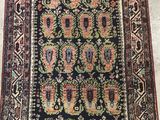 a black and red rug with an ornate design on it