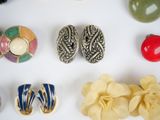 many different types of jewelry displayed on a white surface