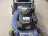 a blue lawn mower sitting on the floor in the garage