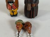 three figurines that are sitting on a white surface