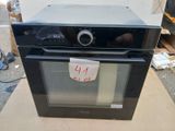 a black oven sitting on top of a cardboard box