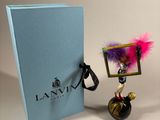 a small figurine that is next to a blue box