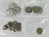 a lot of coins in a plastic bag on a table