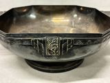 an antique silver bowl with a decorative design on the bottom