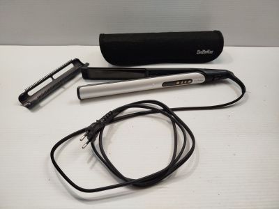 a hair dryer and a hair brush on a table