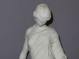 a statue of a woman holding a basket of flowers
