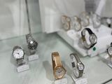 a lot of watches on display in a glass case