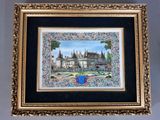 tableau représentant un château, dans un cadre doré, accroché au mur