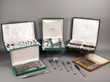 several different types of silverware in a case on a table