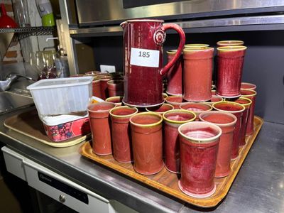 many cups of red liquid on a tray in the kitchen