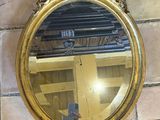 a round mirror hanging on the wall in a room