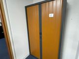 a door in the corner of a room with a sign on it