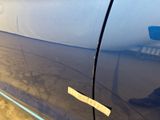 a sticker on the door of a car that has a sticker attached to it
