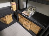 two black shelves with boxes on them in a room