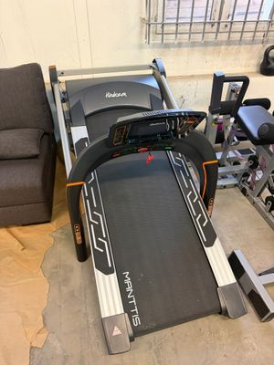 the tread machine is sitting in the corner of the room