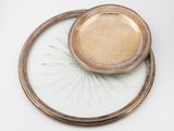 a silver plate with a bowl on top of it