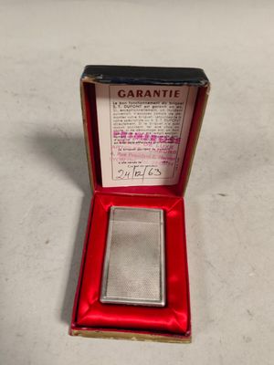 an old cigarette case with a cigarette in it sitting on a table